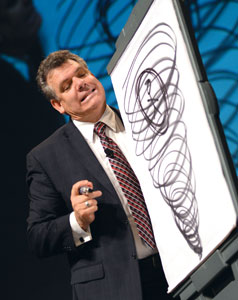 Michael Hoffman grimaces during his Keynote Address Tuesday as he demonstrates the plight of a meeting planner trapped in an F5 tornado - Photo credit to AIBTM